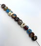 Handmade brown, ivory and turquoise patterned lamp work glass beads - Image 9