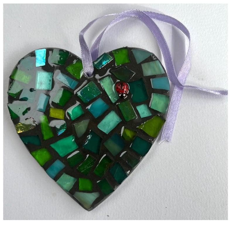 A beautiful heart shaped mosaic pendant made from iridescent glass.