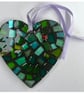 A beatiful heart shaped mosaic pendant made from iridescent glass.
