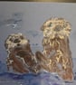 Otters frolicking on A5 paper 