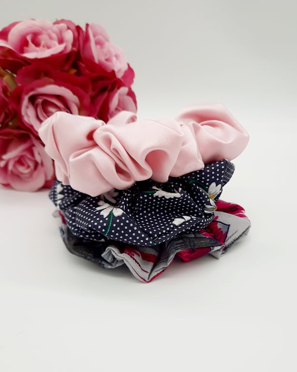 Stack of 3 scrunchies,  navy polkadot,  pink satin and grey raspberry pink. 