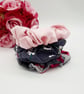 Stack of 3 scrunchies,  navy polkadot,  pink satin and grey raspberry pink. 