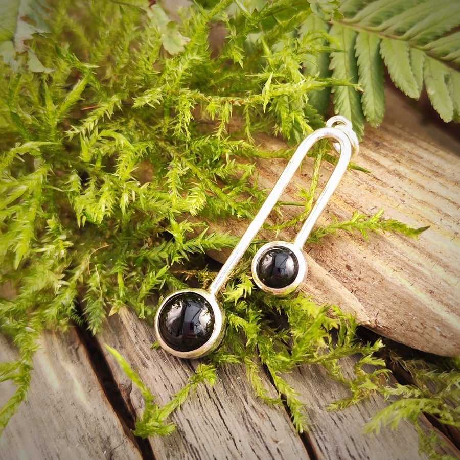Sterling silver pendant with two black onyx cabochons