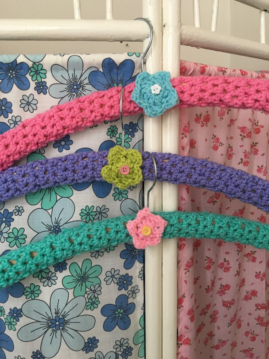 3 crochet covered hangers with crochet flowers