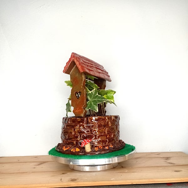 Ceramic hand made wishing well planter indoor.