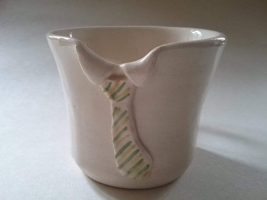 Hand-thrown ceramic pottery collar mug or cup with green and yellow striped tie.