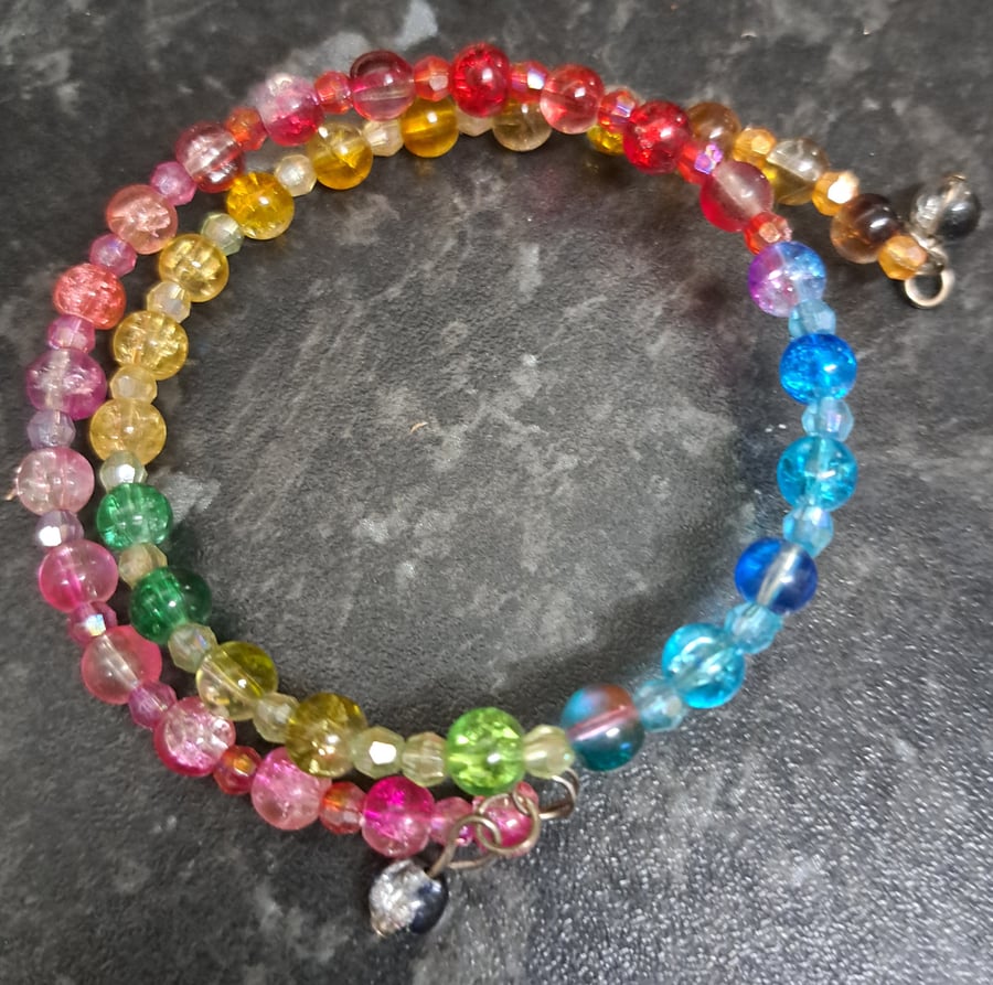 Multicoloured beaded bracelet set on a wrap wire.