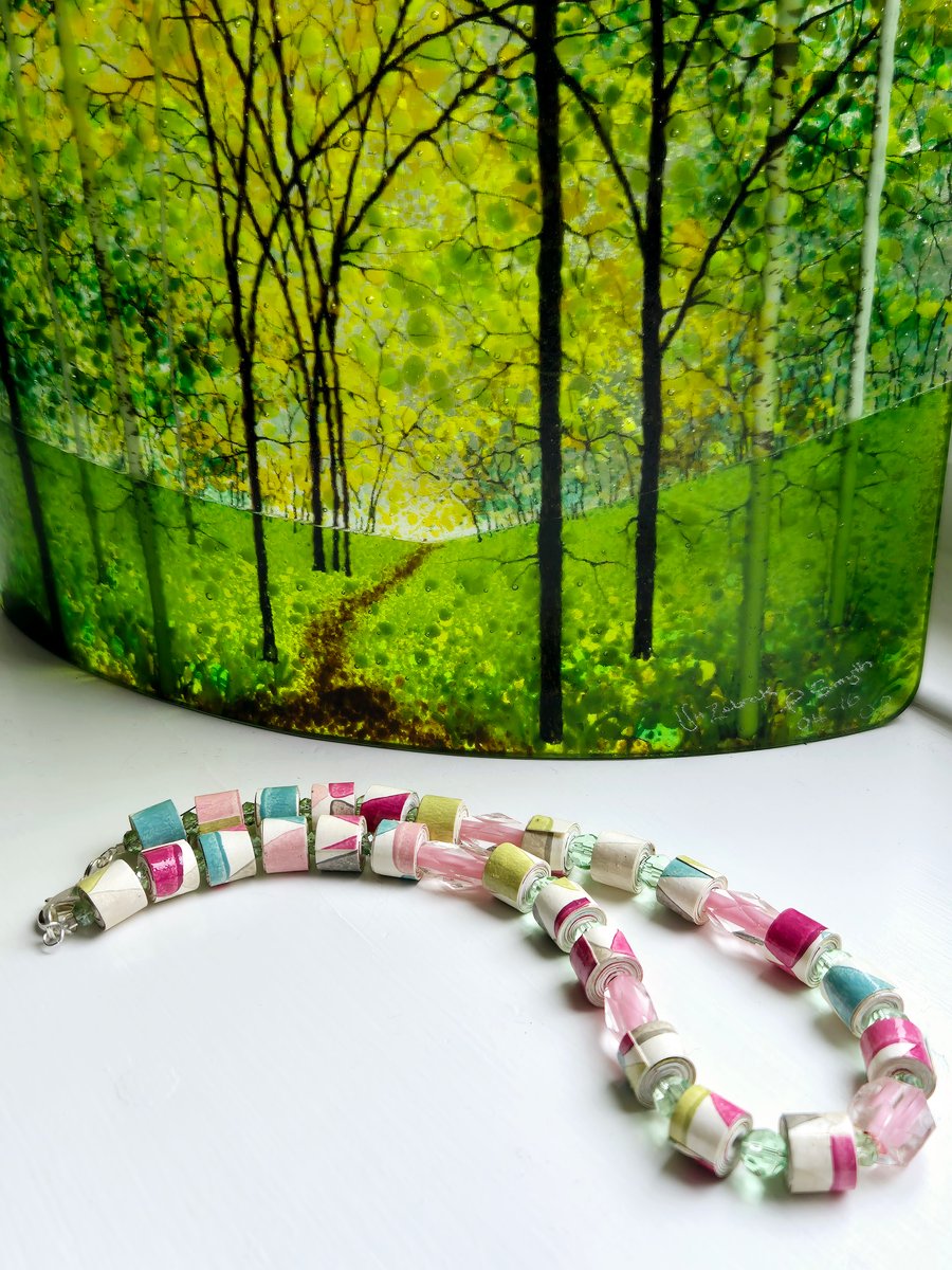 A joyous necklace made of hand rolled wall paper and preloved pastel beads