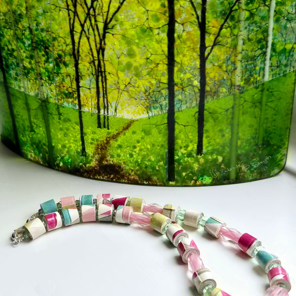 A joyous necklace made of hand rolled wall paper and preloved pastel beads