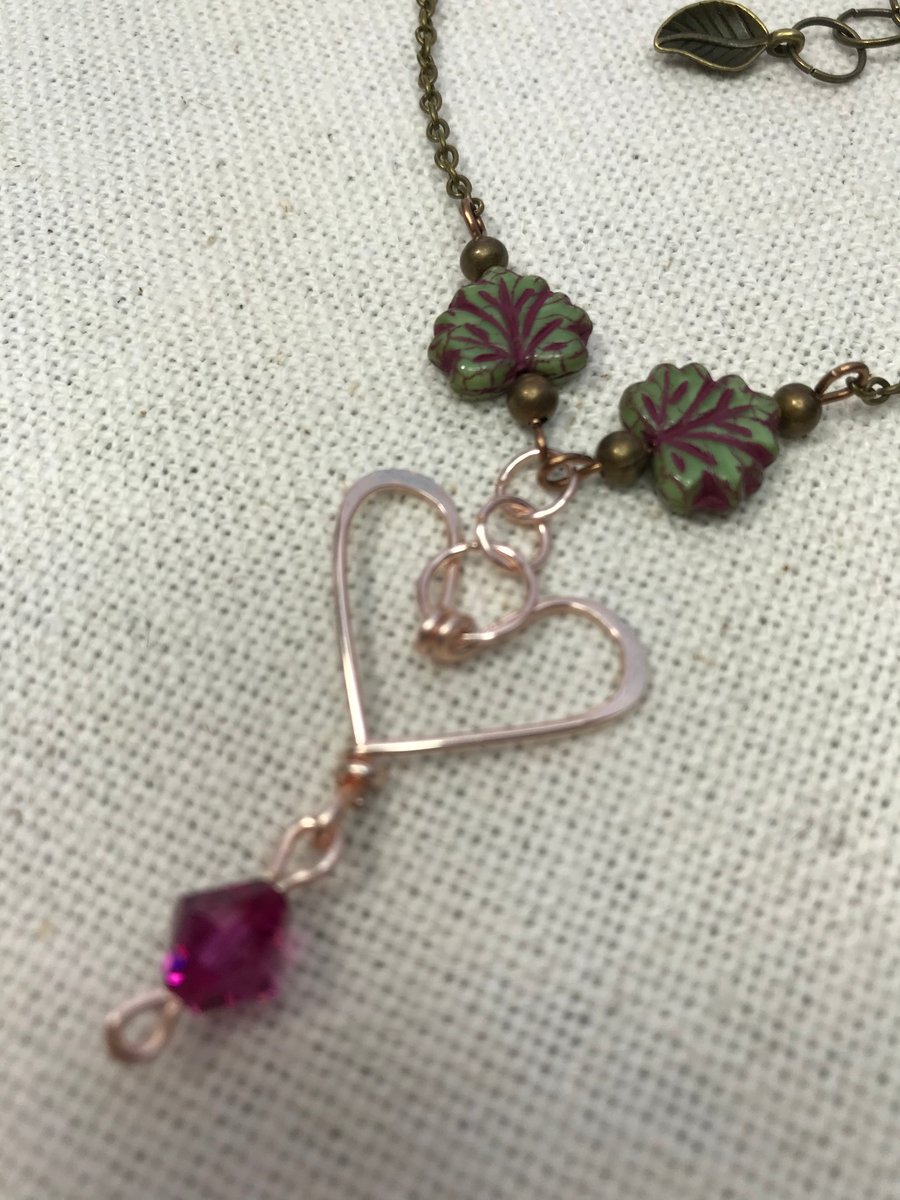 A handmade heart necklace pendant with a Swarovski crystal