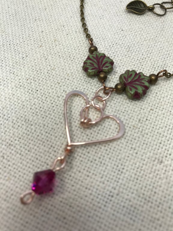 A handmade heart necklace pendant with a Swarovski crystal