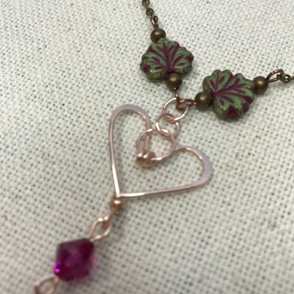 A handmade heart necklace pendant with a Swarovski crystal
