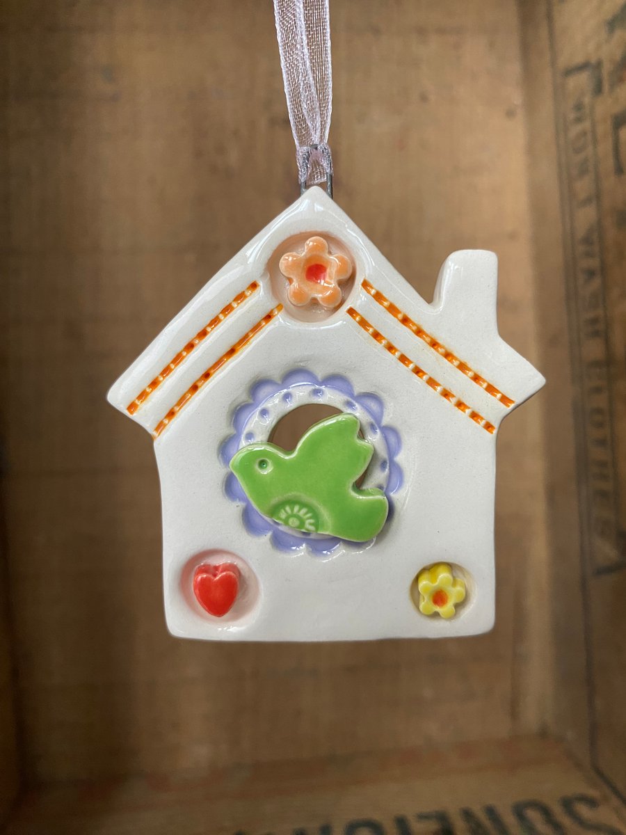 Small Ceramic bird house decoration with small orange flower