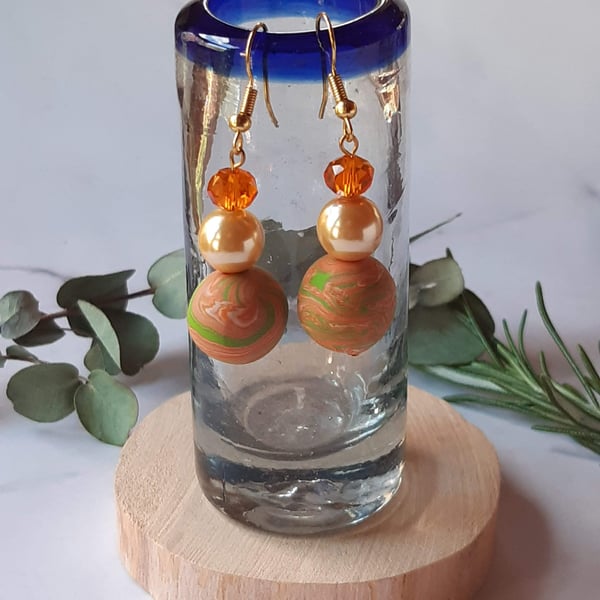 Handmade dangly polymer clay earrings  in tangerine and green