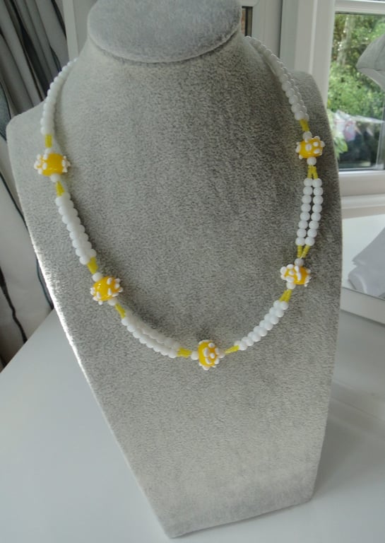 Necklace with handmade lemon yellow glass beads with white dots 