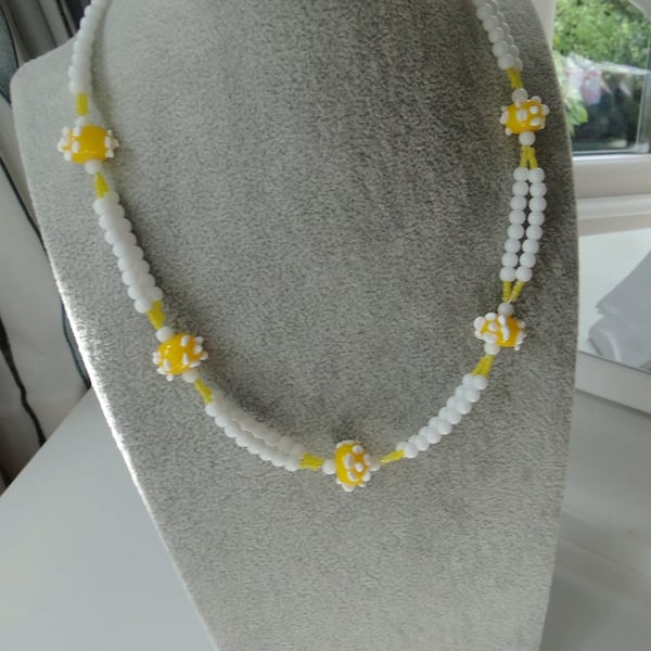 Necklace with handmade lemon yellow glass beads with white dots 