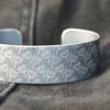 Geometric seed head print cuff bracelet grey
