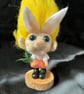 munchkin bunny in white dungerees