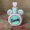 Teeny decorative ceramic love potion bottle. Pink