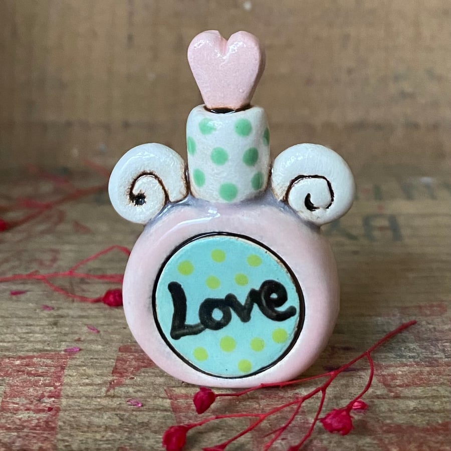Teeny decorative ceramic love potion bottle. Pink