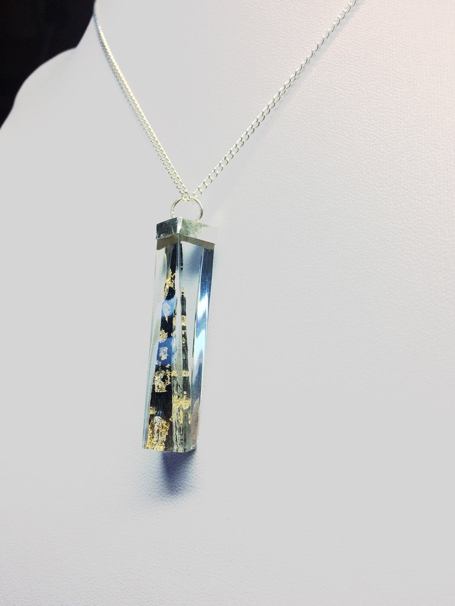 Ebony Shard with Gold Leaf set in a Twisted Crystal Resin Pendulum.