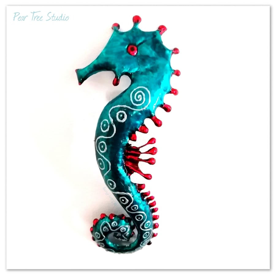 Turquoise and Red metal Seahorse wall decoration. Made from a coffee tin.