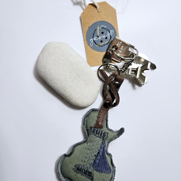 Denim accessories, key or bag charm in the shape of a guitar.