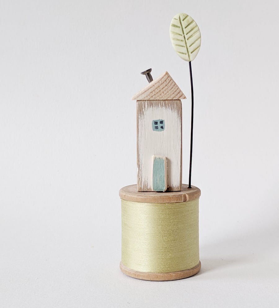 Wooden House on a Vintage Bobbin with Clay Tree