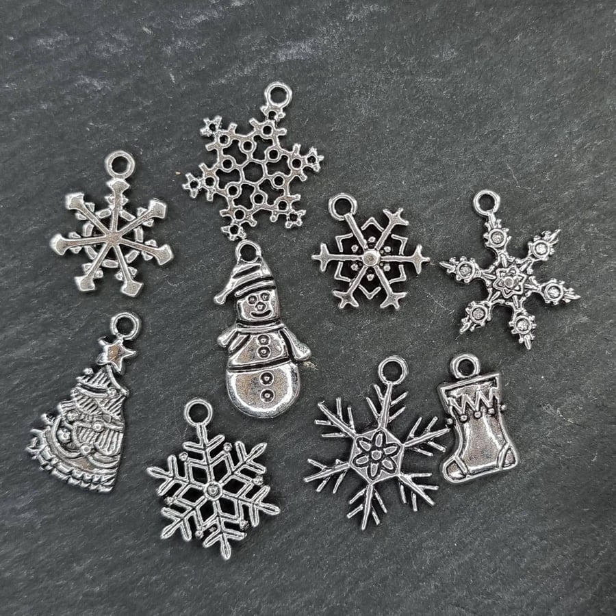 9 Antiqued silver tone Christmas theme charms 