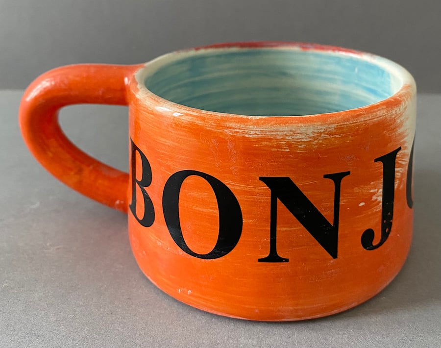 Bonjour ceramic coffee cup.
