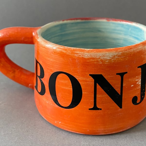 Bonjour ceramic coffee cup.