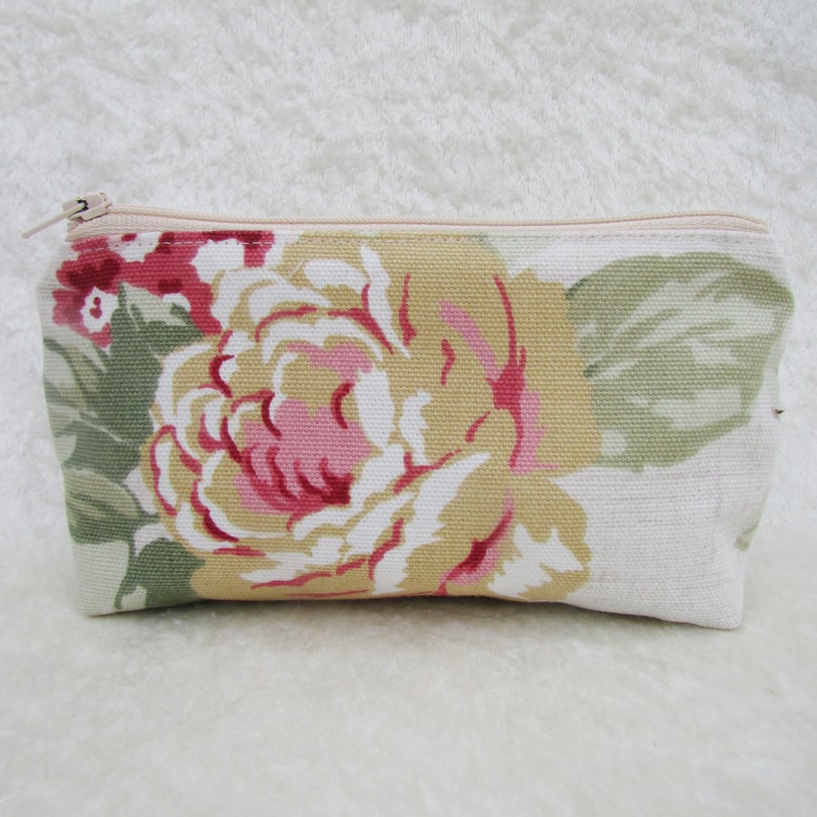 Large purse in floral fabric featuring a golden yellow rose