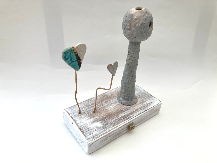 Clay sculpture on wood, ceramic art, clay creature, home decor