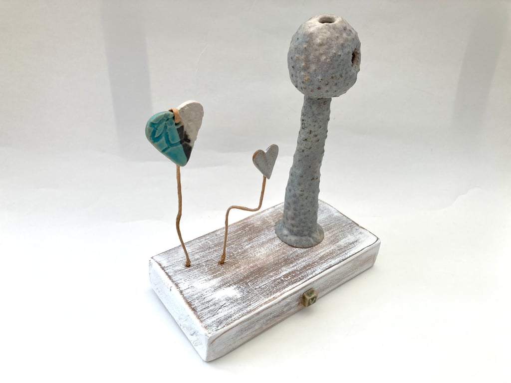 Clay sculpture on wood, ceramic art, clay creature, home decor