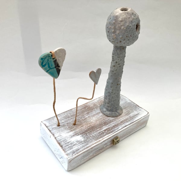 Clay sculpture on wood, ceramic art, clay creature, home decor
