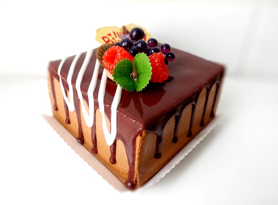 Fake Food Chocolate Drizzle Birthday Cake topped with fruit 