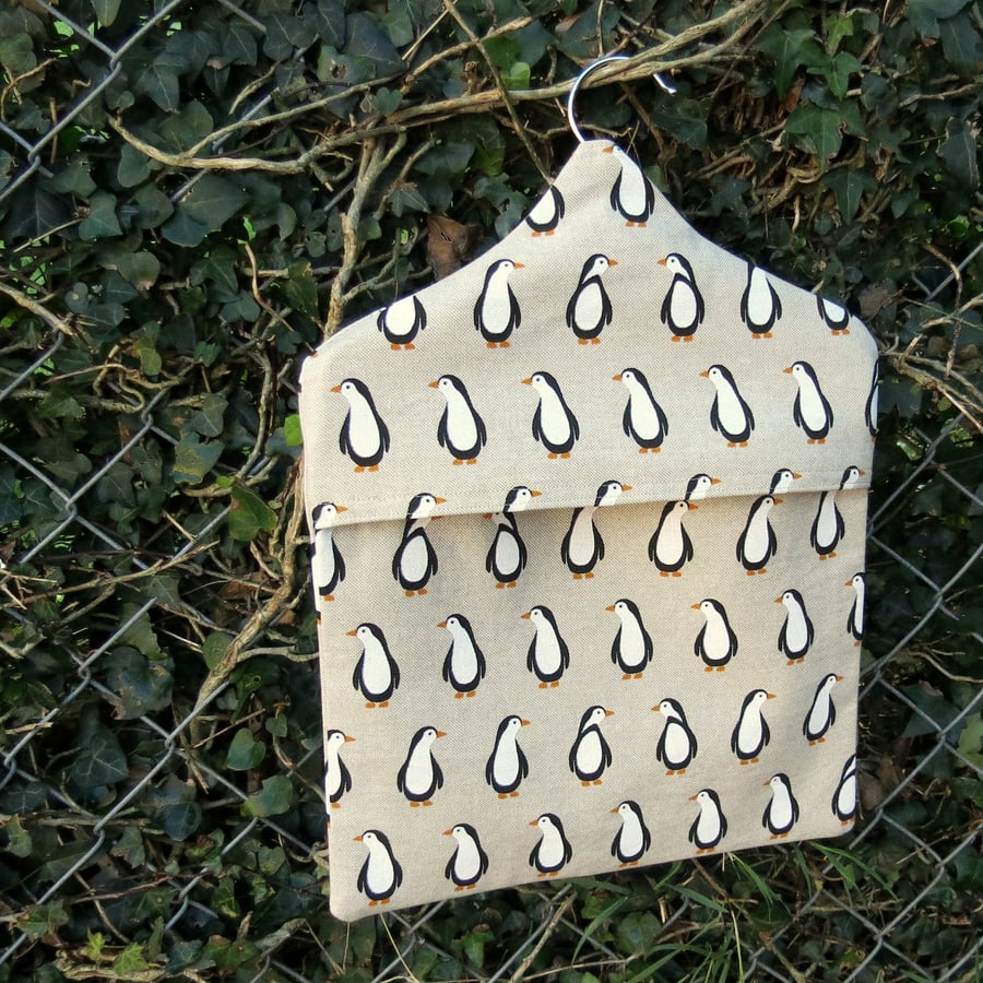 A peg bag with a penguins design.  Peg storage.  Lined peg bag.