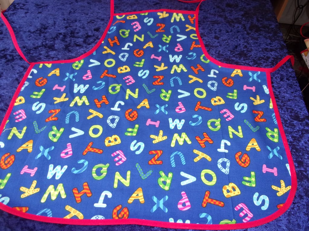 Colourful Alphabet Baby Apron with Red Bias Binding