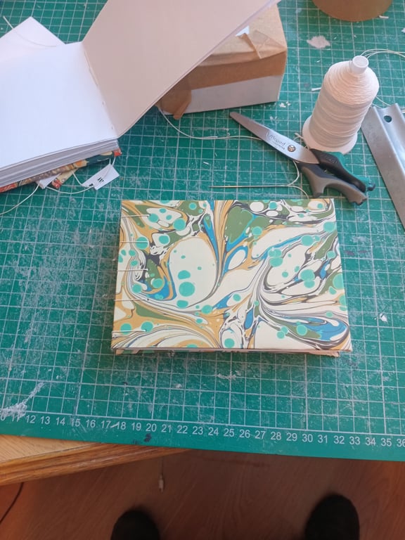 A6 portrait indian cotton paper sketchbook.  Smooth texture,  Coptic stitch.