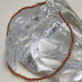 AL126 Orange seed bead anklet