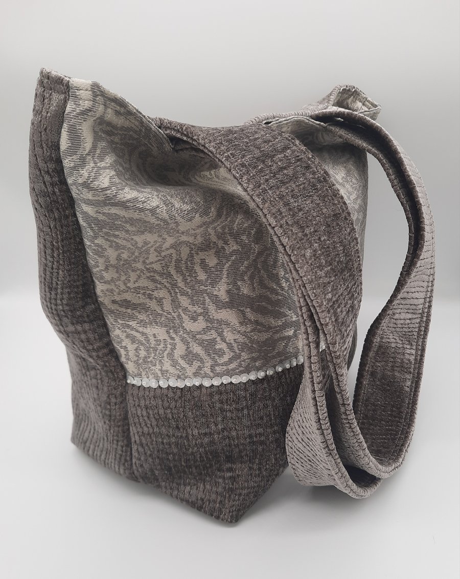 Grey chenille handbag with sequin detail and inside pockets. 