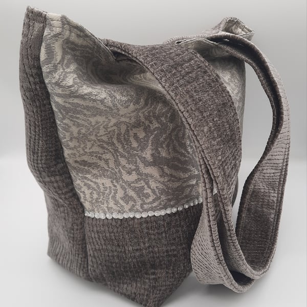 Grey chenille handbag with sequin detail and inside pockets. 