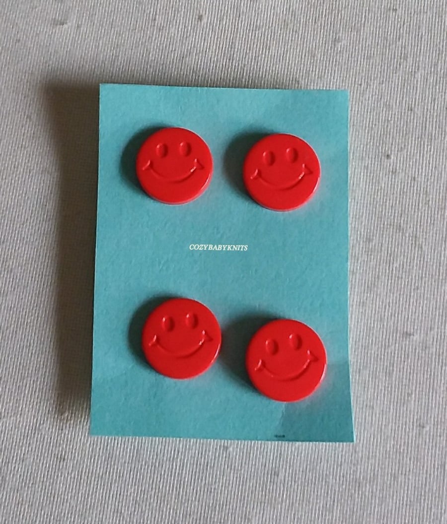 Red smiley face buttons