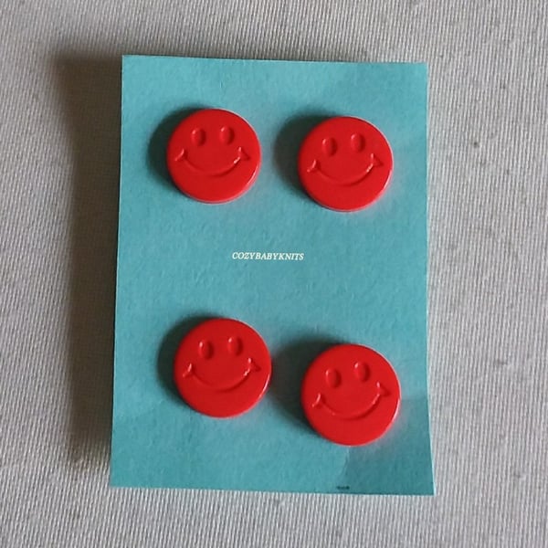 Red smiley face buttons