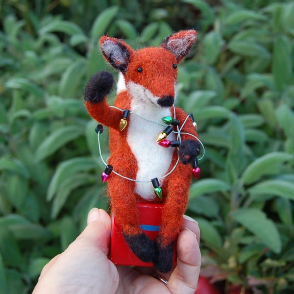 Fox tangled in Xmas lights  sat on a wood alphabet block   - needle felt.   
