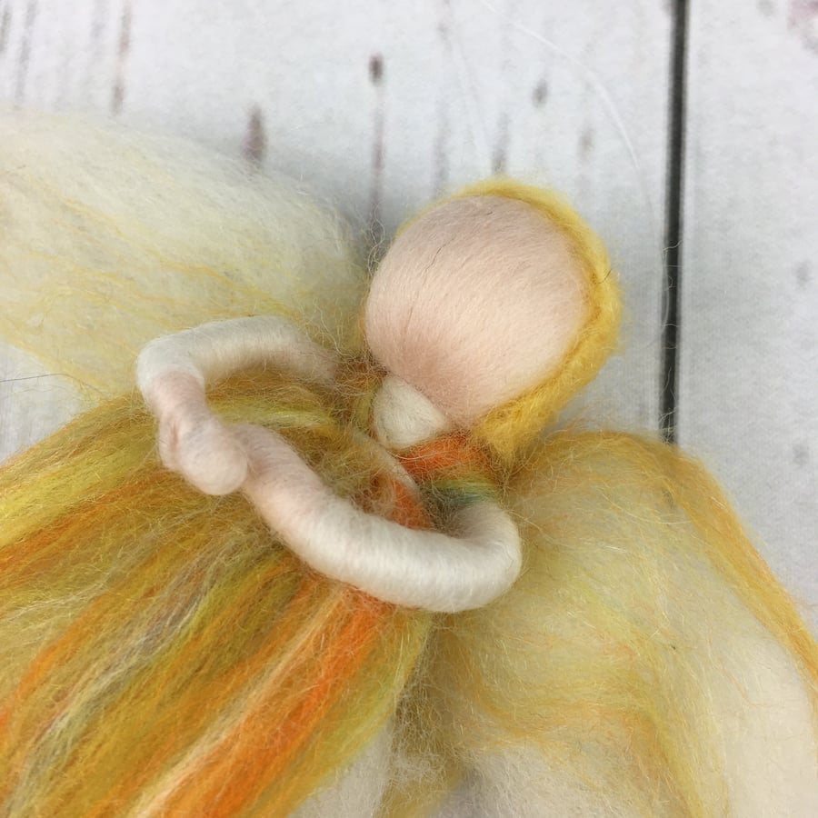 Hanging fairy or angel decoration in green, orange and pink merino wool fibres