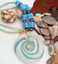 White Glass Pendant with Gold and Blue Cosmic Swirls on a Beaded Necklace - Image 1
