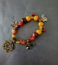 Elasticated nature-inspired beaded charm bracelet with pentacle - Image 1