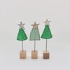 A Christmas Tree with a Wire Stem and Wooden Block Stand