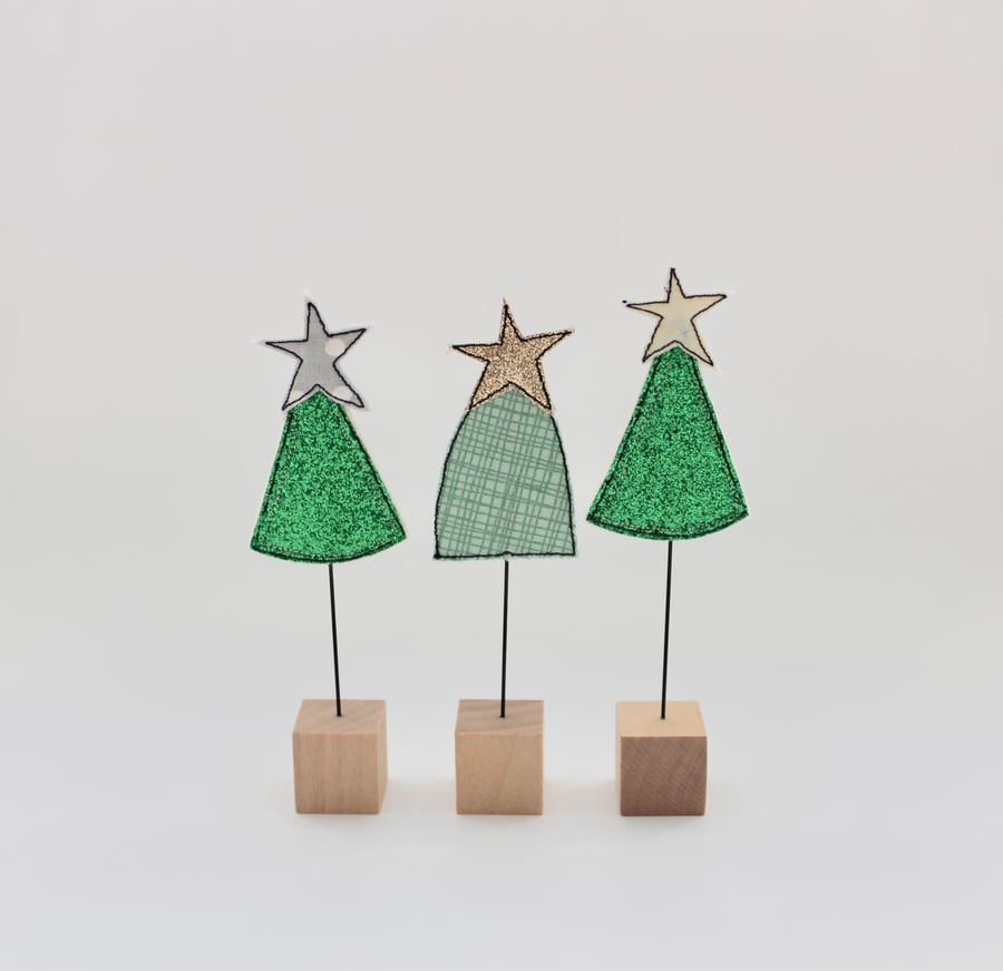 A Christmas Tree with a Wire Stem and Wooden Block Stand